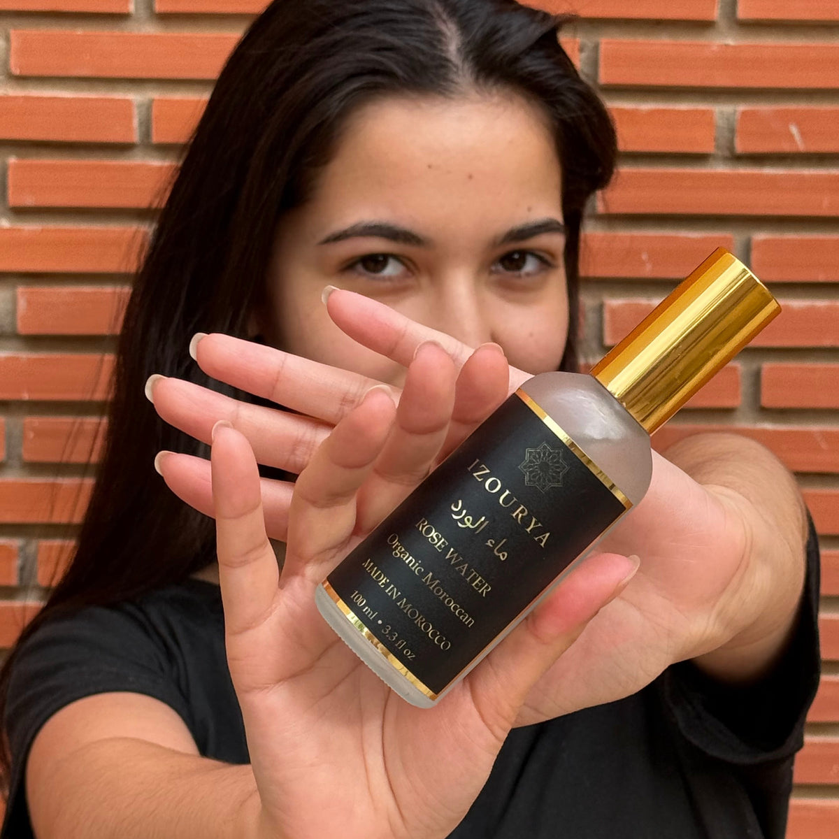 A girl holding Izourya rose water